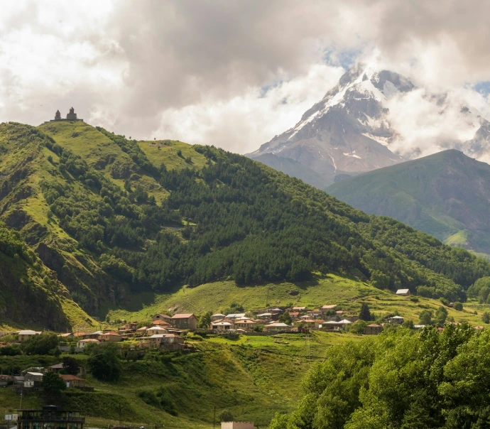 A scenic view of a valley with mountains in the background